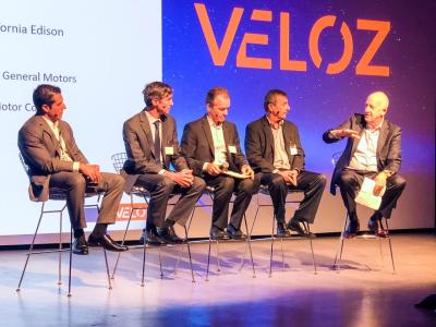 SCE President Ron Nichols (right) explores the future of EVs with car manufacturer representatives at the Veloz forum in Los Angeles.