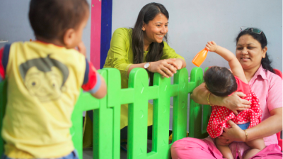 Srishti Warman plays with a mother and children at the Society of Friends of Sassoon Hospitals (SOFOSH) in Pune, India.