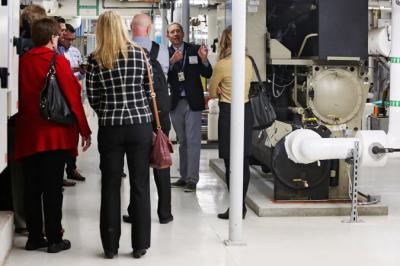Patrick Hamilton, director of global change initiatives at the Science Museum of Minnesota at the University of Florida (at right) describes an upgraded chilled water system designed to lower environmental impact following a ceremony recognizing the Science Museum of Minnesota with the Energy Efficiency Leader Award from Trane on Jan. 16