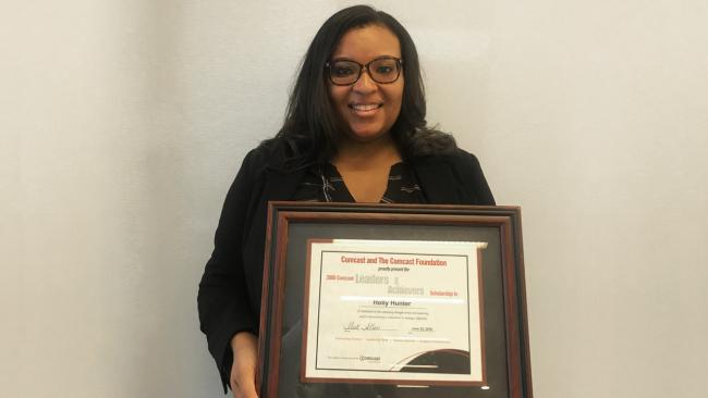 Holly Doyle holding the Leaders and Achievers award certificate she received more than 10 years ago.