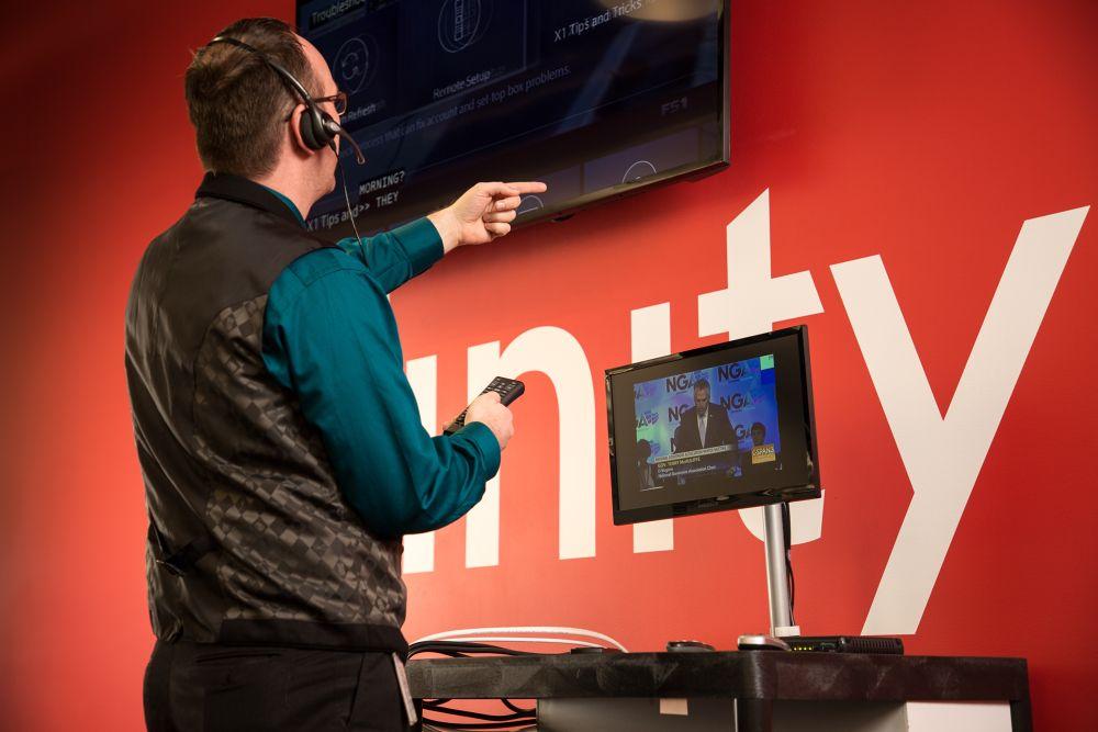 An agent at the Liberty Lake Center of Excellence handles technology while walking a customer through a solution.