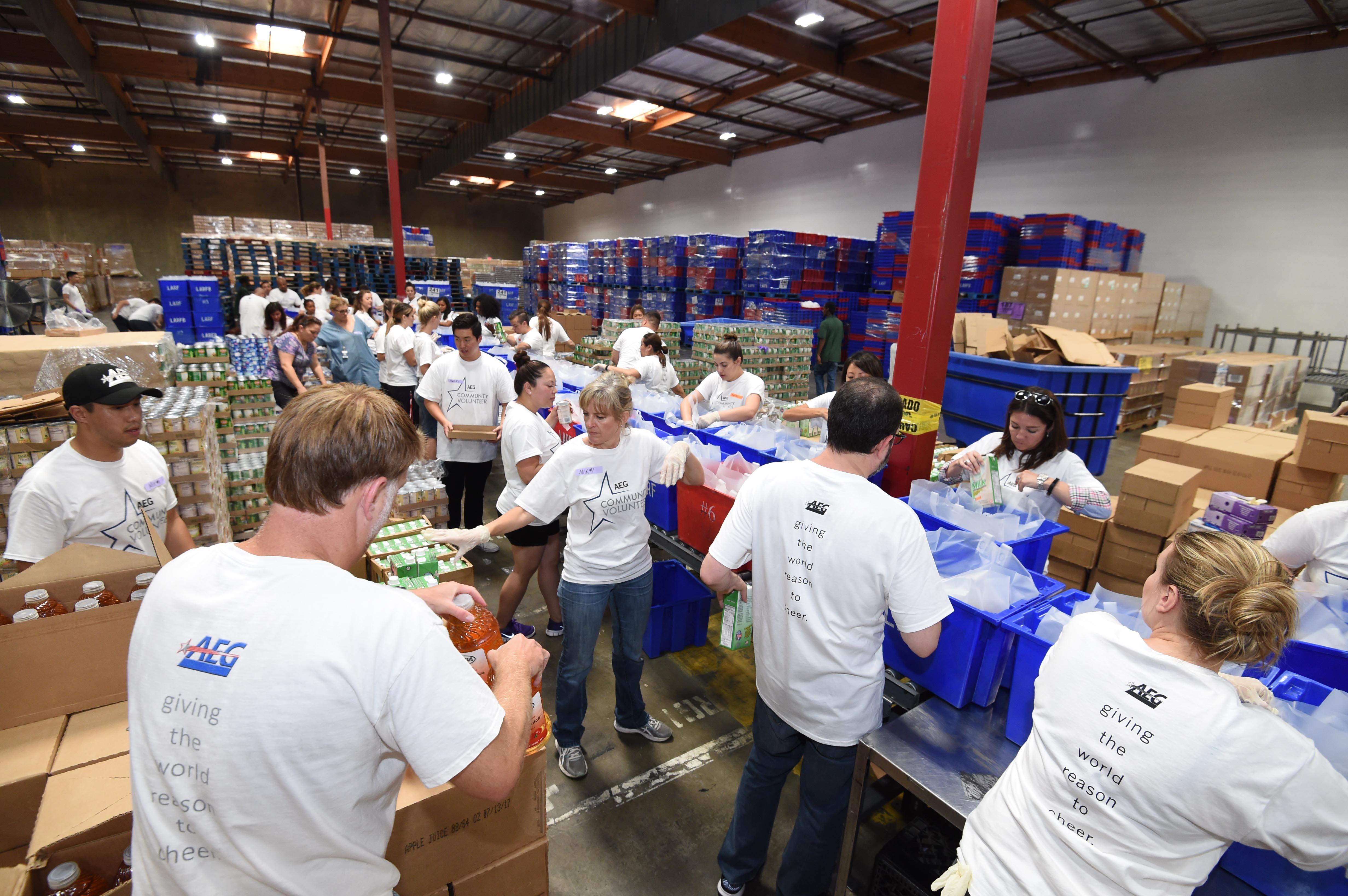 AEG employees prepare more than 1,400 food kits to be distributed to seniors in the greater Los Angeles area on an assembly line at the Los Angeles Regional Food Bank in Commerce, Calif. on Aug. 29, 2017.