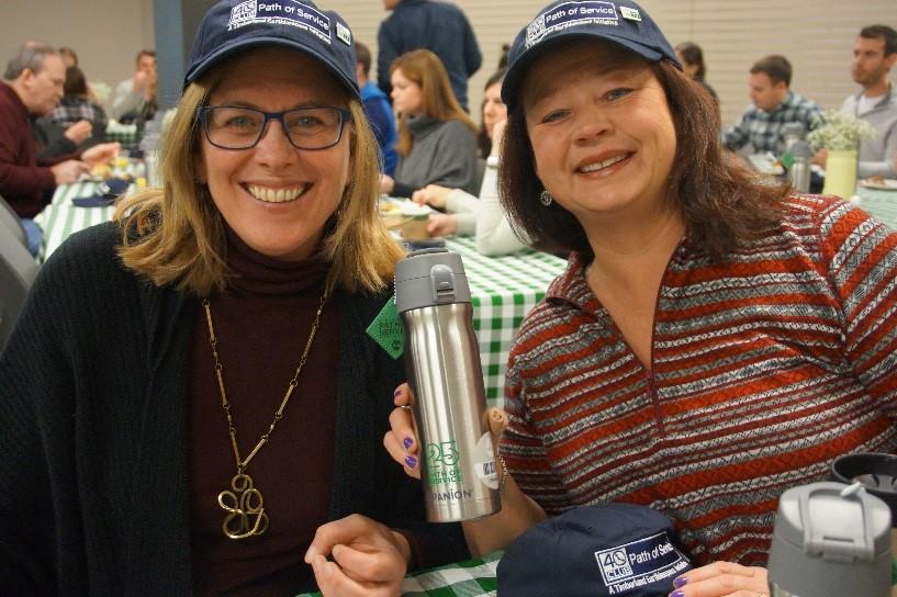 Employees show off their 40’s Club hats, pins, water bottles, and hang tags at Timberland’s annual 40’s Club breakfast to celebrate Timberland’s volunteer champions. The 40’s Club members served all of their 40 available service hours in 2017.