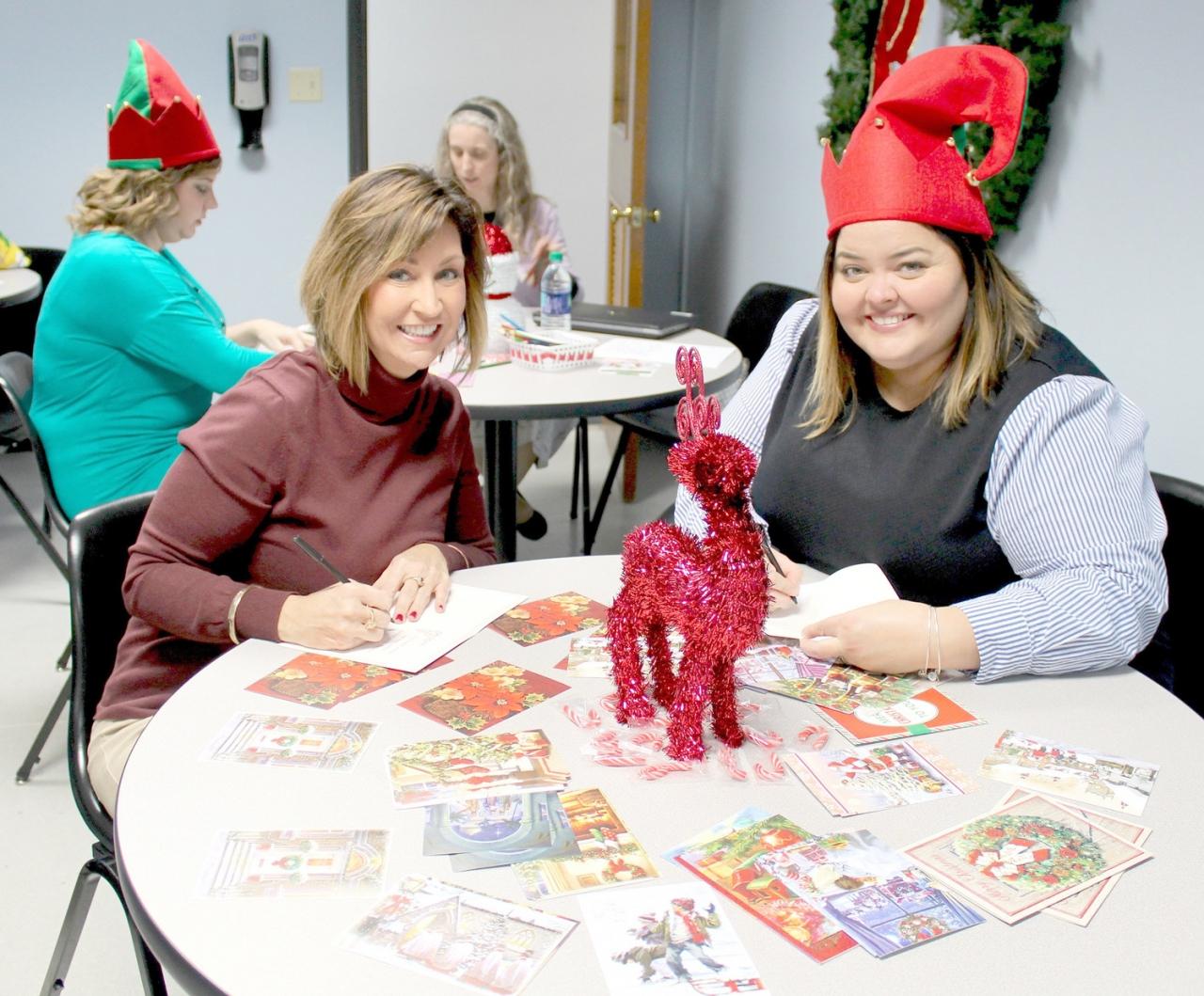 WHIRLPOOL Customer eXperience Center employees Patti Bowerman, left, and Shannon Russo prepare cards for the American Red Cross' "Holidays for Heroes" initiative.