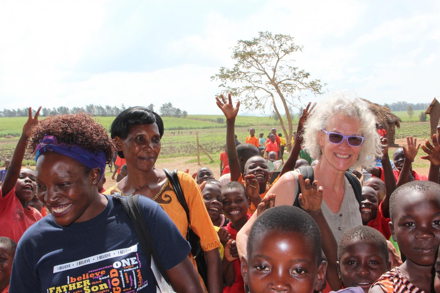 Ellie (right) pictured with two women who run sewing guilds that produce reusable MoonCatcher pads in Uganda.